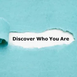 paper ripped with words that say Discover Who You Are underneath